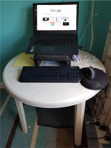 Laptop on a plastic patio table